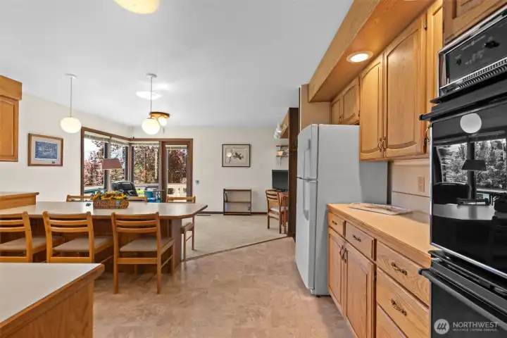 Kitchen and family room.. with access to the wrap around deck at the back toward the course