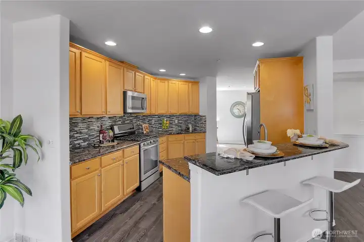 Updated kitchen with counter/bar dining, stainless appliances with gas cooking