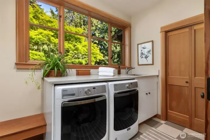 Laundry/mudroom with lovely window and ample storage for coats and shoes. Convenient laundry chute from upstairs too.