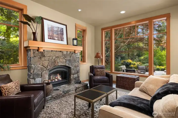 Cozy fireplace room has beautiful stonework and a VG fir mantel
