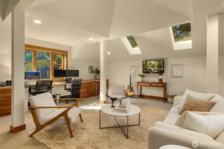 Large light filled flex room over the garage attached by interior walkway with ample storage, built in cabinets and desk space
