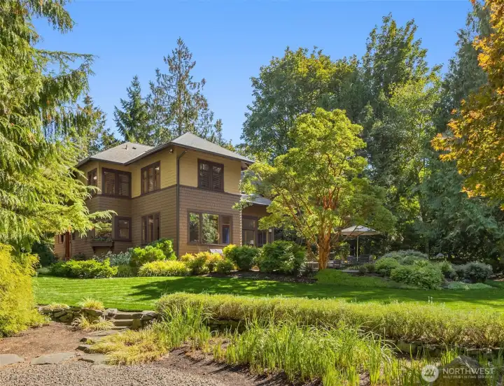 Extensive beautiful landscaping, paths, pavers and arbor with multiple varieties of Japanese maples and pines