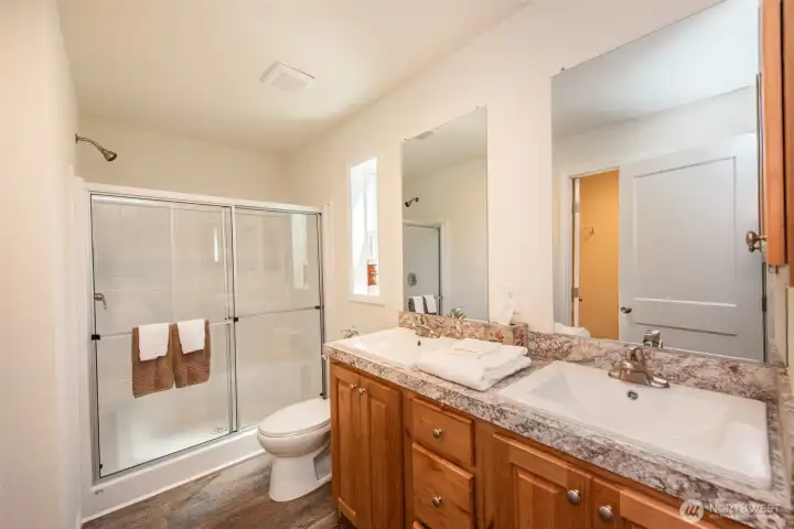 Primary bathroom with dual sinks and walk in shower Primary bathroom with dual sinks and walk in shower