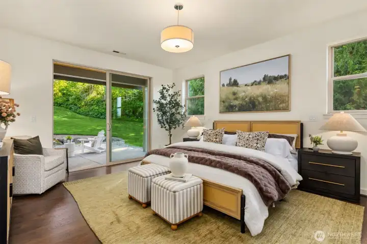 The main floor primary suite offers a private outlook and access to the back patio and yard area. The main floor primary suite offers a private outlook and access to the back patio and yard area.