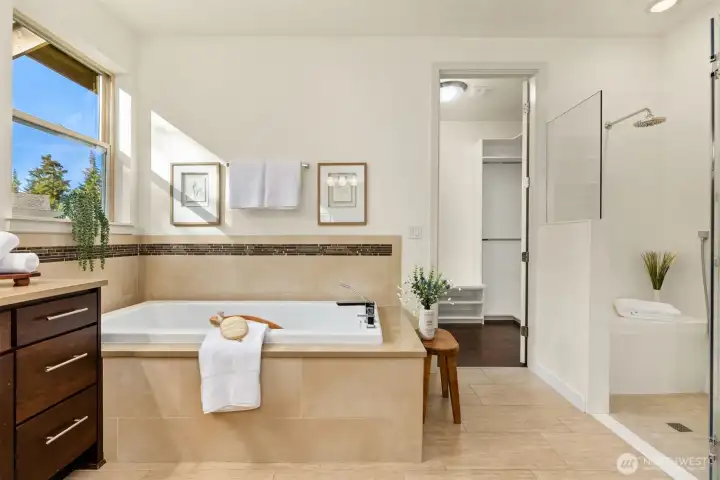 Main floor bath shows the soaking tub and walk in shower off to the right. Private toilet. Main floor bath shows the soaking tub and walk in shower off to the right. Private toilet.