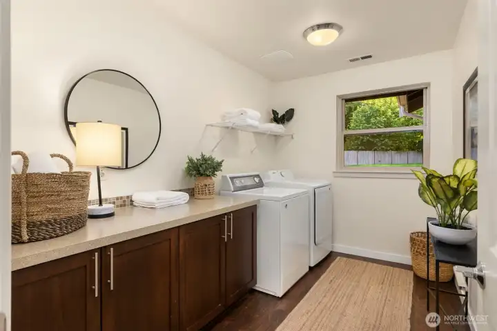 Upper level laundry room has counter space to organize and natural light. Full sized washer and dryer. Remember the main floor primary bedroom also has a laundry hook up ( no W/D) if needed. Upper level laundry room has counter space to organize and natural light. Full sized washer and dryer. Remember the main floor primary bedroom also has a laundry hook up ( no W/D) if needed.