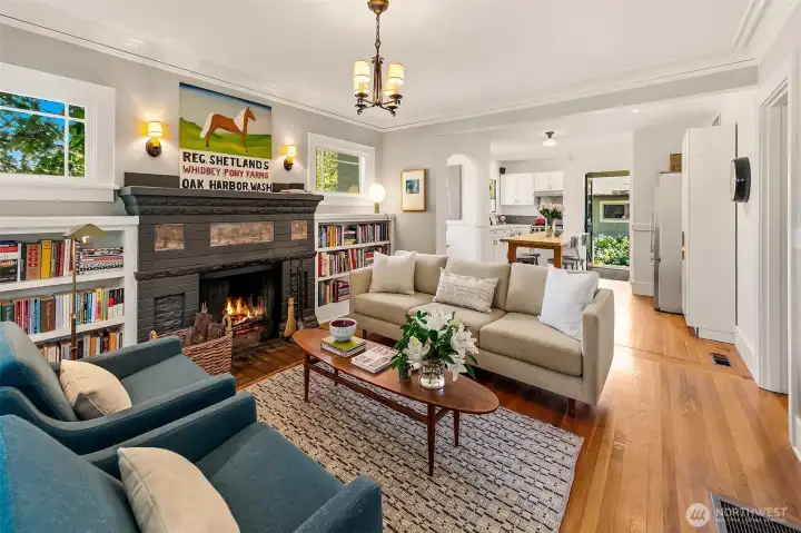 Once inside you will find refinished original fir floors, a substantial fireplace with brick mantle, restored vintage lighting all open to the kitchen. Once inside you will find refinished original fir floors, a substantial fireplace with brick mantle, restored vintage lighting all open to the kitchen.
