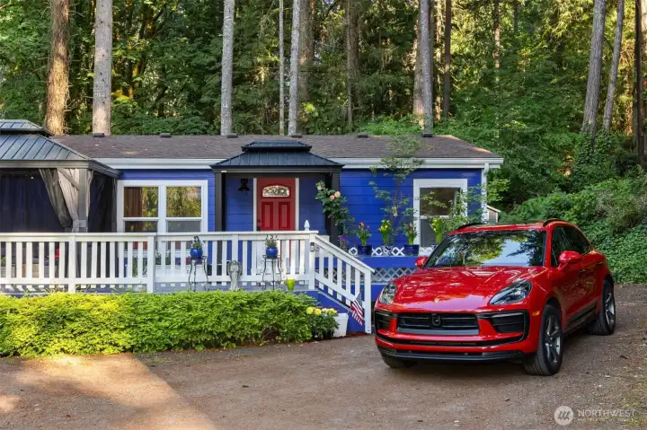 Beautiful evergreens are the backdrop to this sweet, one-level living home.
