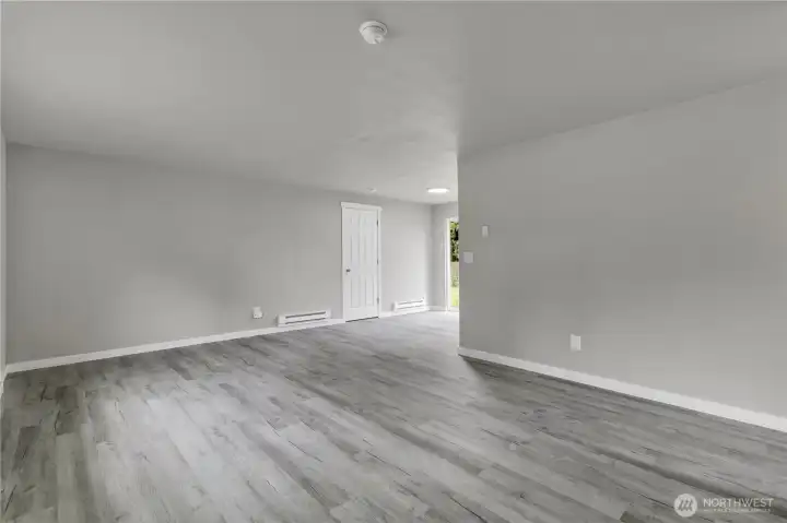 Large open living room with new plank flooring!