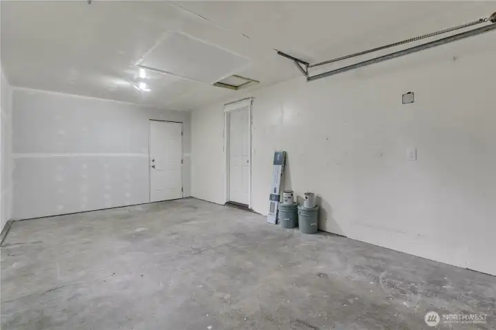 Spacious 1 car attached garage with man door to the backyard