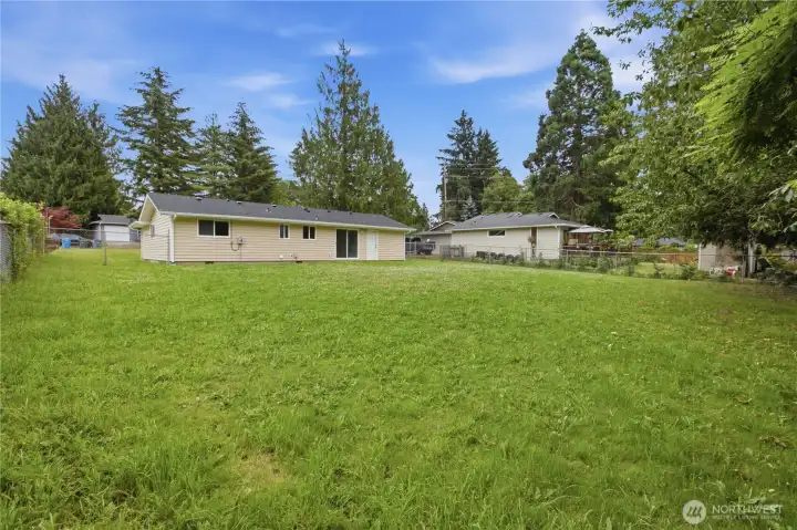 Come enjoy summer BBQs in this gigantic yard with room for volleyball, corn hole, baseball and more!