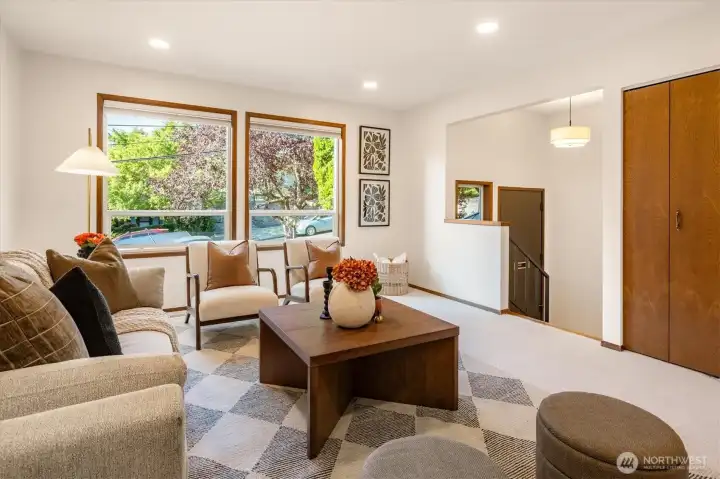The spacious living room is bright, and sits up above the driveway, looking out at the street trees. The top down, bottom up blinds allow for privacy and light. The spacious living room is bright, and sits up above the driveway, looking out at the street trees. The top down, bottom up blinds allow for privacy and light.