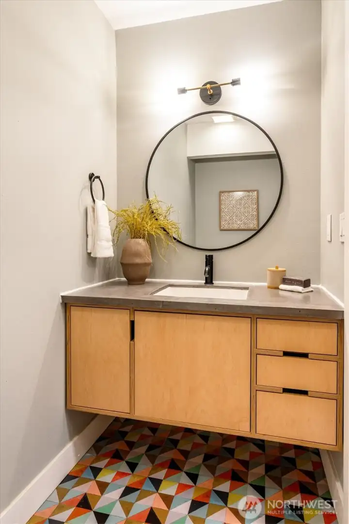 The stylish powder room on the main floor, is updated with Seattle-based Kerf cabinetry. The stylish powder room on the main floor, is updated with Seattle-based Kerf cabinetry.