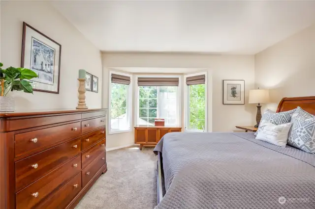 Primary suite has bay window overlooking your private yard