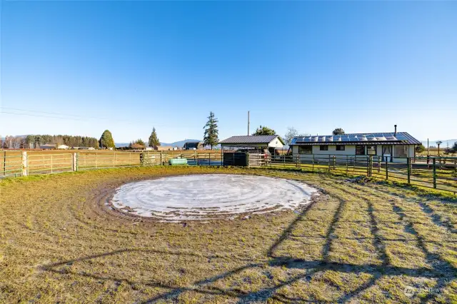 Viewing onto the round pen.  A 2 car carport and dog run.