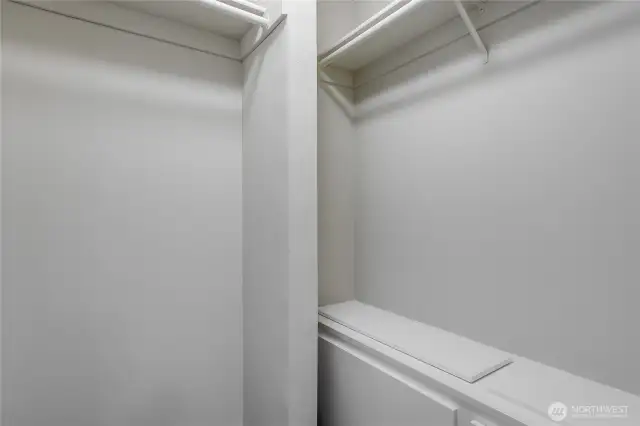 Primary closet with built in cabinet with safe.