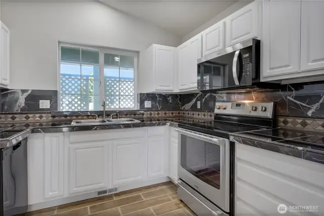 Great cabinet space in kitchen with new dishwasher and microwave.