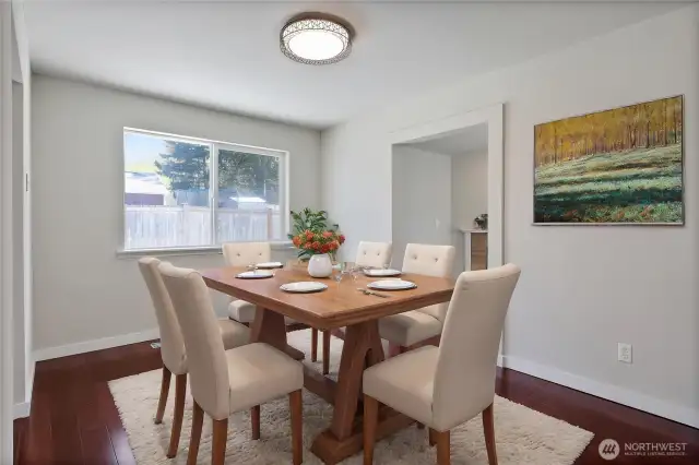Virtually staged dining room off kitchen and living space.