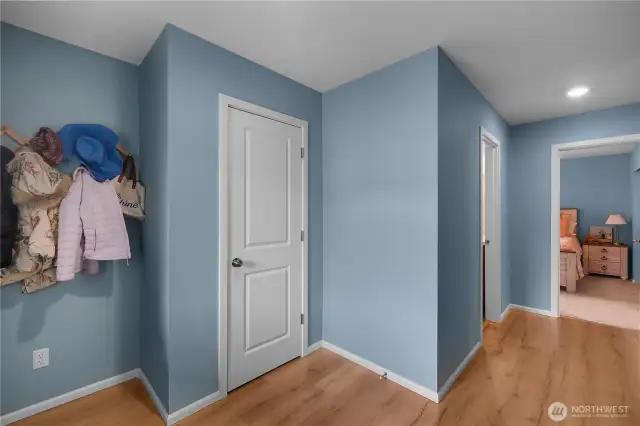 Large Entryway with nook and coat closet. Main floor bedroom ahead, full bath to left.