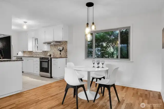 another view of the dining area. To the left is the staircase that goes down to the lower level, and to the right is a fabulous flex space to use as a walk-in pantry, office, or both!