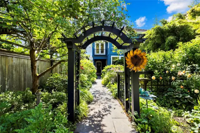 Enchanting gardens surround the home, with stone paths winding through the grounds fit for a master gardener.