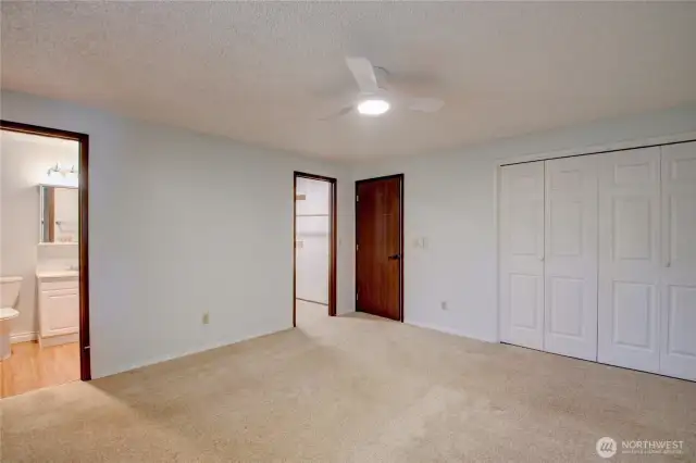 Primary bedroom looking toward the 3/4 en-suite bathroom and walk in closet