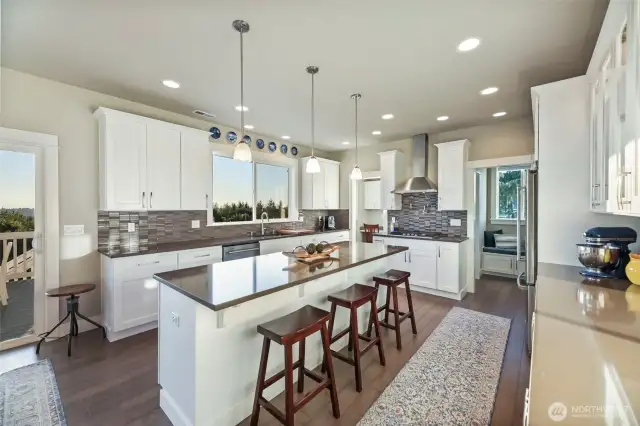 Not to be missed quartz countertops that line the kitchen with a large prepping island down the middle.