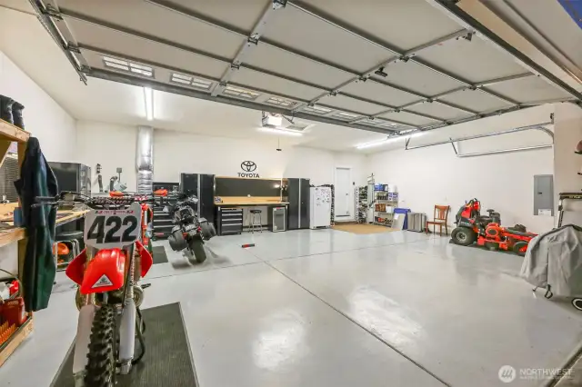 Oversized 3-car garage ready for all your vehicles and toys! Cabinets and shelves stay!