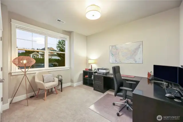 Main floor 4th bedroom- currently used as a home office with gorgeous sunrise views right off the front entry