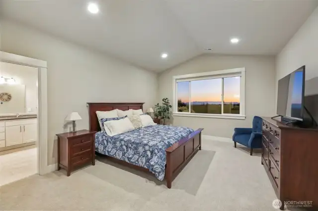 French doors lead into your main floor private retreat with vaulted ceilings welcoming you to a restful sleep.