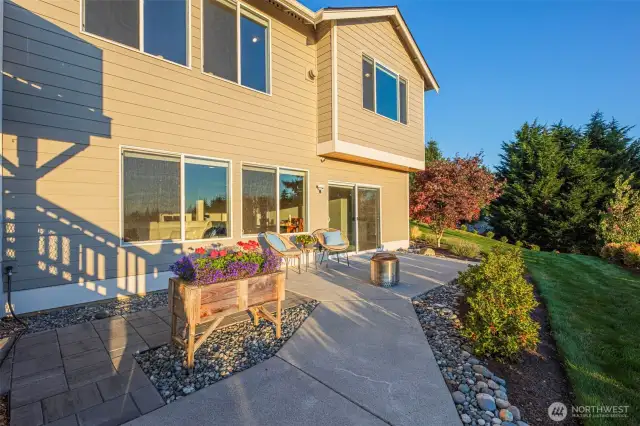 Patio pathway runs along the back of the home to reach the dog run and the garden.
