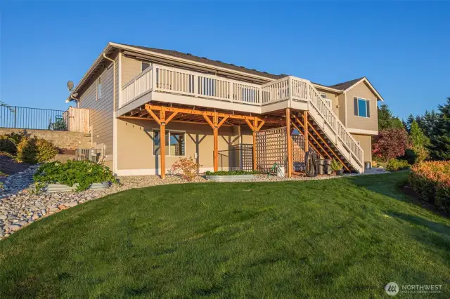 Fully fenced dog run under the deck with a great garden to the left of the home.
