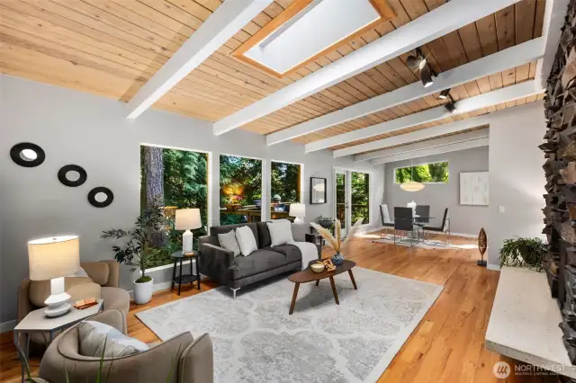 Vaulted beamed ceilings and skylights welcome you to the large living room