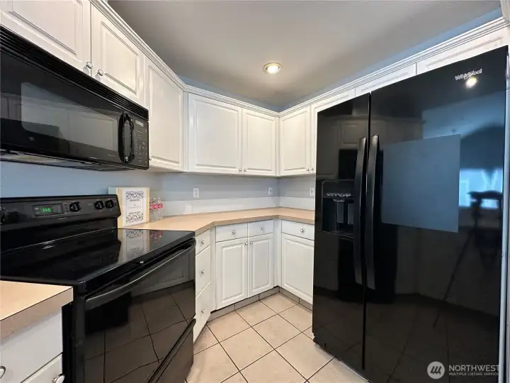 Kitchen is set up for convenience. Lots of countertops and cabinets!