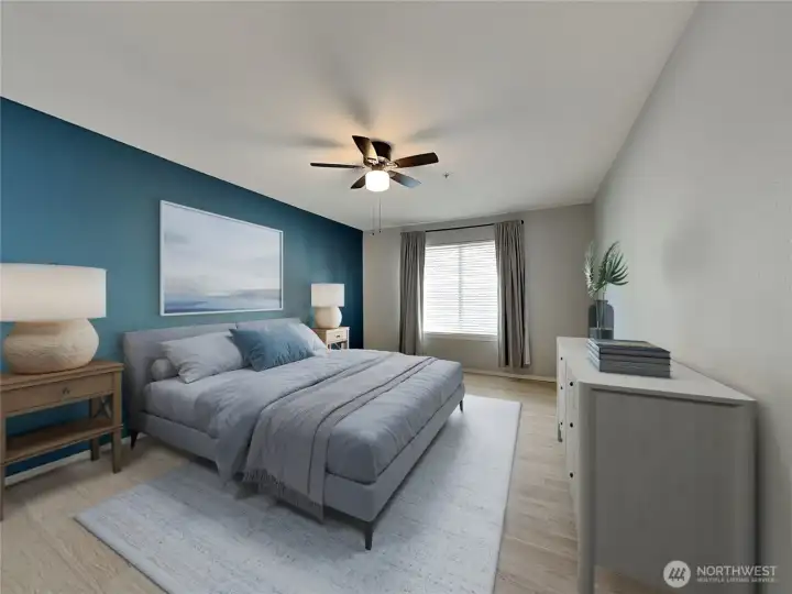 Primary bedroom with ceiling fan and big window