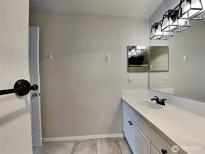 Primary bathroom sink, and new light fixtures
