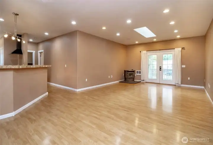 Light filled living room with pellet fireplace and French doors