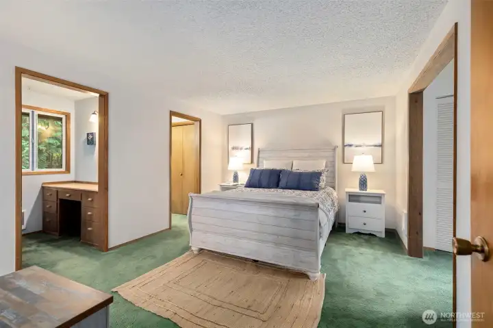 Large main floor primary suite with dual closets/dressing area