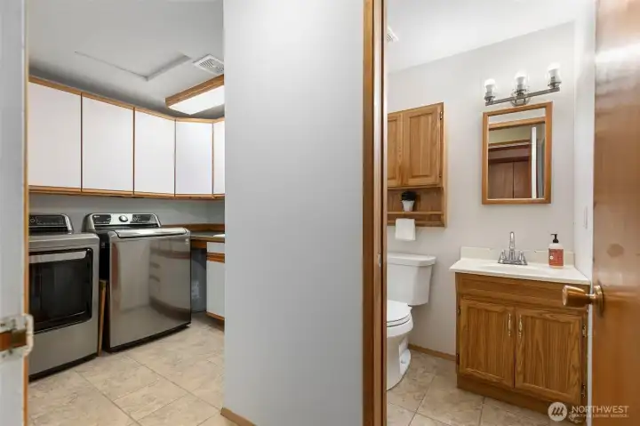 Main floor laundry room with practical guest 1/2 bath just off the main hallway