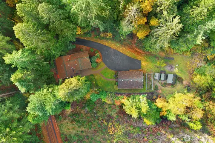 Aerial view of the home with private paved driveway and RV parking