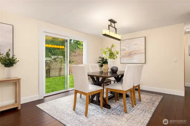 Large glass sliding doors lead to fenced back yard.