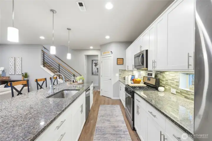 Spacious kitchen layout with generous counter space and open sightlines into living areas, perfect for hosting and everyday convenience.