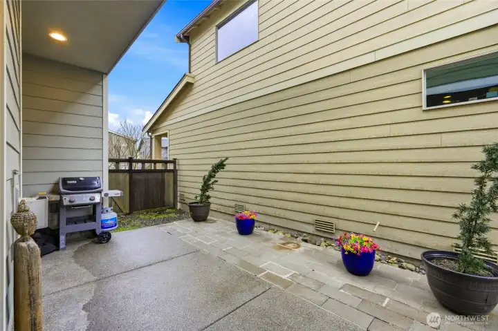 Private outdoor side patio space ideal for grilling, relaxing, and low-maintenance outdoor living in Ten Trails community.
