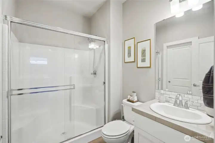 Modern bathroom with clean finishes, glass shower on the main, and updated fixtures providing comfort and style.