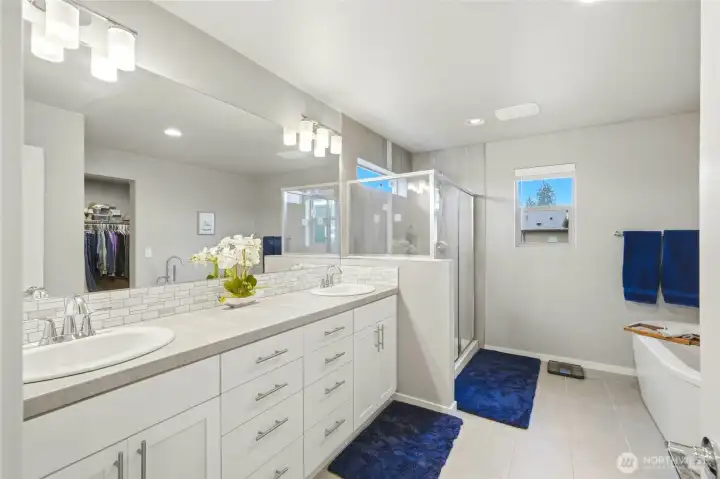 Luxury primary bathroom with dual vanities, ample counter space, and modern finishes for a spa-like feel.