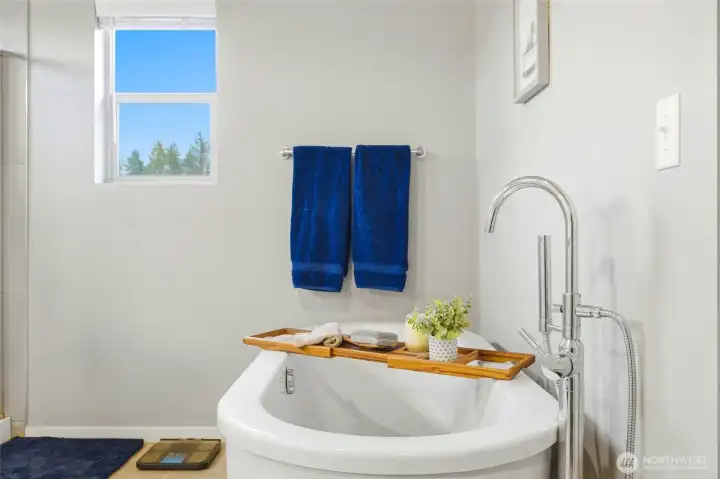 Bright bathroom detail with clean modern finishes, soaking tub, and natural light creating a relaxing and functional space.