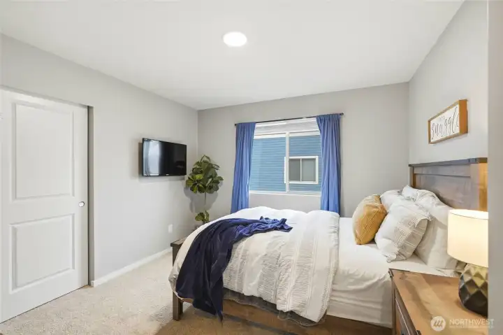 Large bedroom with modern design, ample space, and natural light ideal for comfortable everyday living.