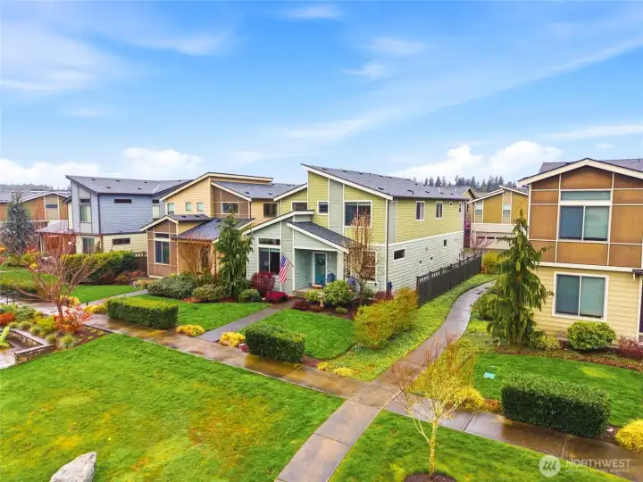 Neighborhood green space with landscaped paths and open areas perfect for outdoor activities and play.