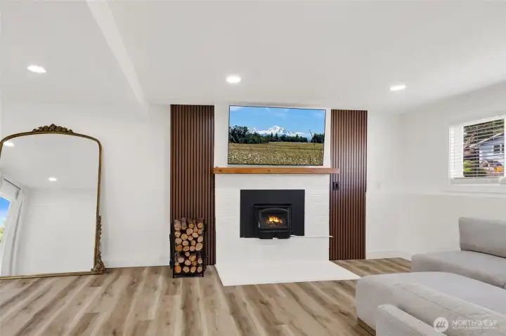 Specious lover-level bonus room featuring wood-burning stove, perfect for relaxing evenings or family time!