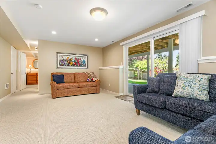 Downstairs family room with sliding door to fenced backyard, patio and pond Downstairs family room with sliding door to fenced backyard, patio and pond